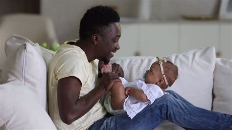 Loving father and cute daughter playing in bed